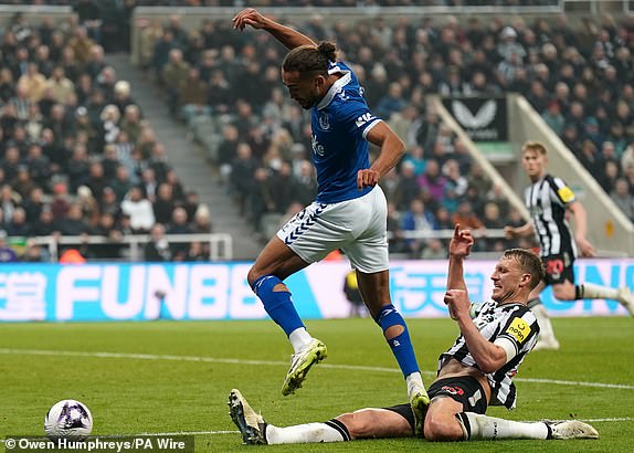 Everton's Dominic Calvert-Lewin (left) and Newcastle United's Dan Burn battle for the ball during the Premier League match at St. James' Park, Newcastle upon Tyne. Picture date: Tuesday April 2, 2024. PA Photo. See PA story SOCCER Newcastle. Photo credit should read: Owen Humphreys/PA Wire.RESTRICTIONS: EDITORIAL USE ONLY No use with unauthorised audio, video, data, fixture lists, club/league logos or "live" services. Online in-match use limited to 120 images, no video emulation. No use in betting, games or single club/league/player publications.