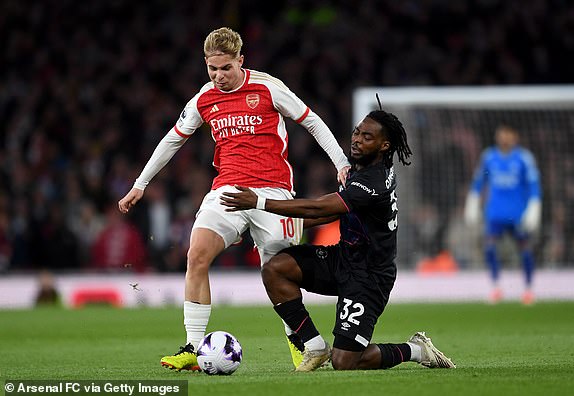 LONDON, ENGLAND - APRIL 03: Emile Smith Rowe of Arsenal is challenged by Fred Onyedinma of Luton Town during the Premier League match between Arsenal FC and Luton Town at Emirates Stadium on April 03, 2024 in London, England. (Photo by David Price/Arsenal FC via Getty Images)