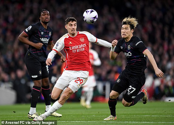 LONDON, ENGLAND - APRIL 03: Kai Havertz of Arsenal and Daiki Hashioka of Luton Town chase the ball during the Premier League match between Arsenal FC and Luton Town at Emirates Stadium on April 03, 2024 in London, England. (Photo by David Price/Arsenal FC via Getty Images)