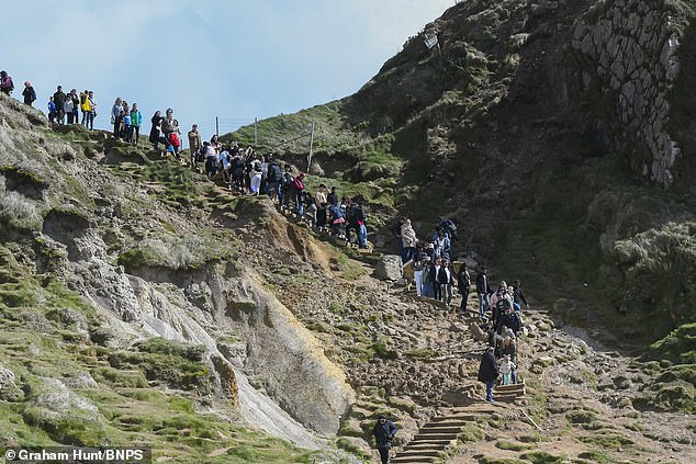 One of Britain's most popular beauty spots was described as 'almost impassable' after coastal erosion buried the only access to the beach at Durdle Door in Dorset