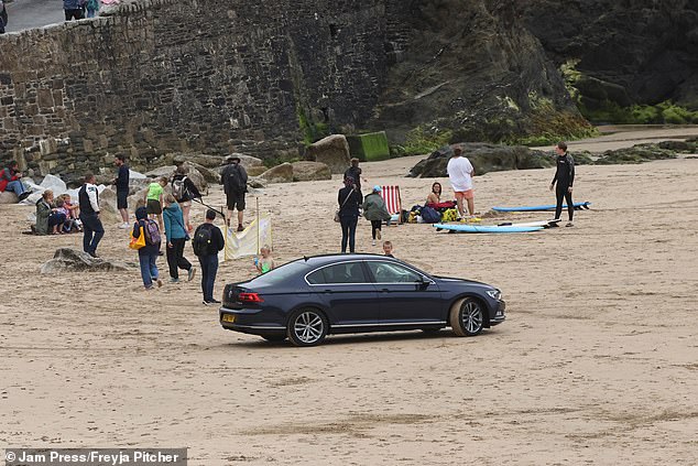 Three Audi-driving visitors were berated by locals for deciding to park on the sand in Newquay