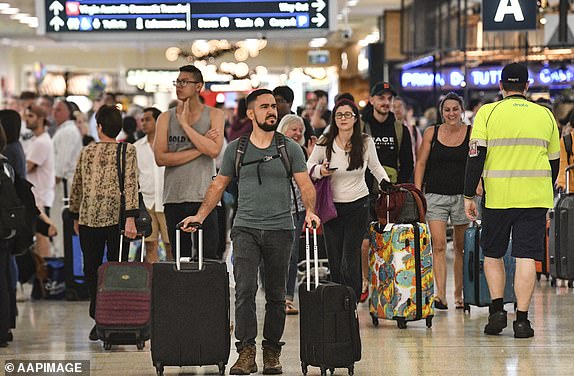 Travellers are seen at Overseas Arrivals and Departures (OAD) at Sydney's International Airport in Sydney, Monday, December 17, 2018. (AAP Image/Brendan Esposito) NO ARCHIVING