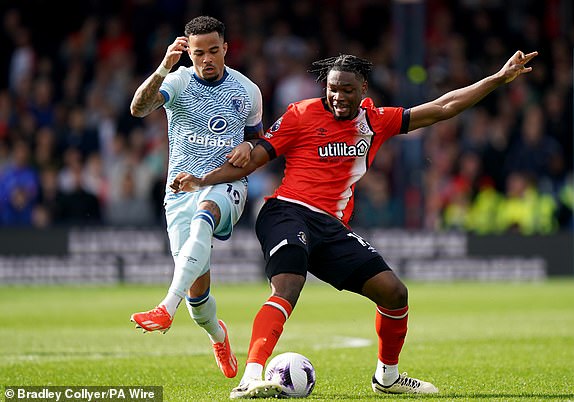 Bournemouth's Justin Kluivert (left) and Luton Town's Teden Mengi battle for the ball during the Premier League match at Kenilworth Road, Luton. Picture date: Saturday April 6, 2024. PA Photo. See PA story SOCCER Luton. Photo credit should read: Bradley Collyer/PA Wire.RESTRICTIONS: EDITORIAL USE ONLY No use with unauthorised audio, video, data, fixture lists, club/league logos or "live" services. Online in-match use limited to 120 images, no video emulation. No use in betting, games or single club/league/player publications.