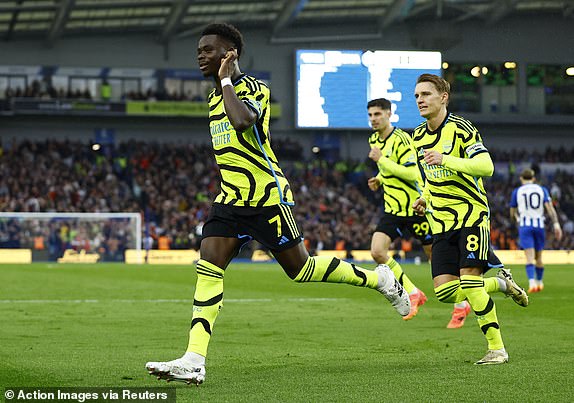 Soccer Football - Premier League - Brighton & Hove Albion v Arsenal - The American Express Community Stadium, Brighton, Britain - April 6, 2024 Arsenal's Bukayo Saka celebrates scoring their first goal Action Images via Reuters/Peter Cziborra NO USE WITH UNAUTHORIZED AUDIO, VIDEO, DATA, FIXTURE LISTS, CLUB/LEAGUE LOGOS OR 'LIVE' SERVICES. ONLINE IN-MATCH USE LIMITED TO 45 IMAGES, NO VIDEO EMULATION. NO USE IN BETTING, GAMES OR SINGLE CLUB/LEAGUE/PLAYER PUBLICATIONS.
