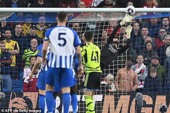 Arsenal's Spanish goalkeeper #22 David Raya makes a save during the English Premier League football match between Brighton and Hove Albion and Arsenal at the American Express Community Stadium in Brighton, southern England on April 6, 2024. (Photo by Glyn KIRK / AFP) / RESTRICTED TO EDITORIAL USE. No use with unauthorized audio, video, data, fixture lists, club/league logos or 'live' services. Online in-match use limited to 120 images. An additional 40 images may be used in extra time. No video emulation. Social media in-match use limited to 120 images. An additional 40 images may be used in extra time. No use in betting publications, games or single club/league/player publications. /  (Photo by GLYN KIRK/AFP via Getty Images)