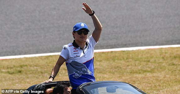 RB's Japanese driver Yuki Tsunoda waves as he takes part in the drivers' parade before the start of the Formula One Japanese Grand Prix race at the Suzuka circuit in Suzuka, Mie prefecture on April 7, 2024. (Photo by Toshifumi KITAMURA / AFP) (Photo by TOSHIFUMI KITAMURA/AFP via Getty Images)