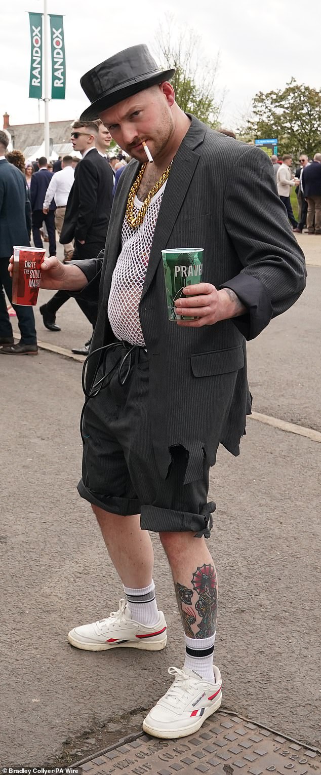 One man chose to wear shorts and a mesh vest top along with a blazer and a chunky gold chain as he poses with a cigarette in his mouth and drinks in both hands