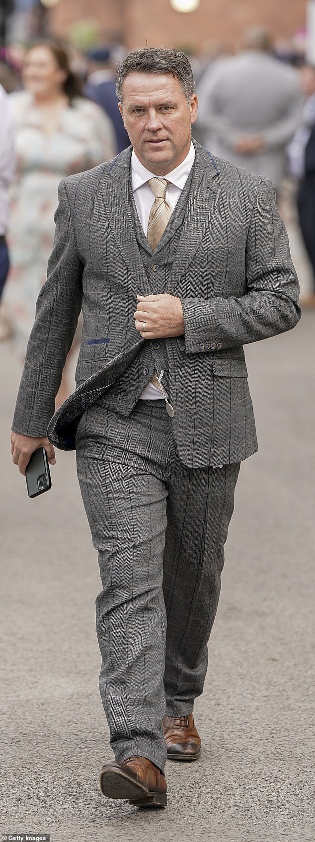Ex-footballer Michael Owen is pictured looking dapper in a smart grey suit as he arrives at Aintree today