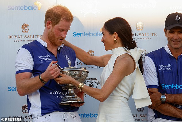 Meghan pulled her husband into a warm embrace as he stared down at his prize