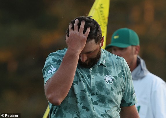 Golf - The Masters - Augusta National Golf Club, Augusta, Georgia, U.S. - April 12, 2024 Spain's Jon Rahm reacts as he walks off the green on the 18th hole after completing his second round REUTERS/Mike Segar