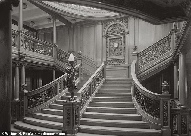 The grand staircase nearer the front of Titanic (the 'fore' grand staircase) had the ornate carved oak wall panel with the clock at the centre. Pictured is the fore grand staircase of sister ship RMS Olympic, thought to be identical to the one on Titanic. No photos of Titanic's grand staircases are known to exist