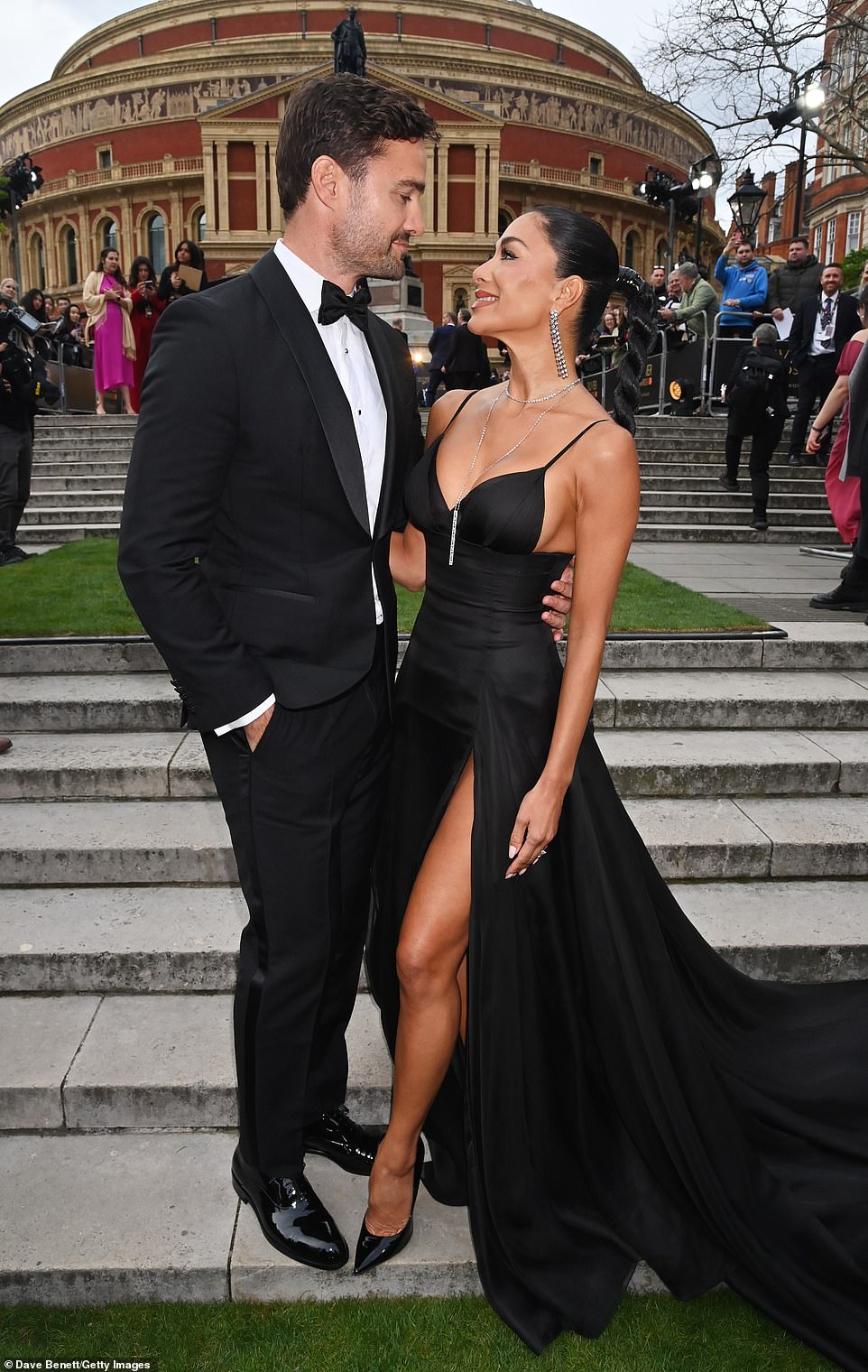 Her raven black hair was styled in a neat plait and she was joined by her fiancé Thom Evans, who looked handsome in a black tuxedo and bow tie