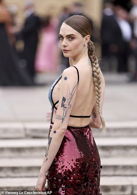 The model-turned-actress plaited her hair into a long braid that flowed down her back and donned a pair of strappy black high heels