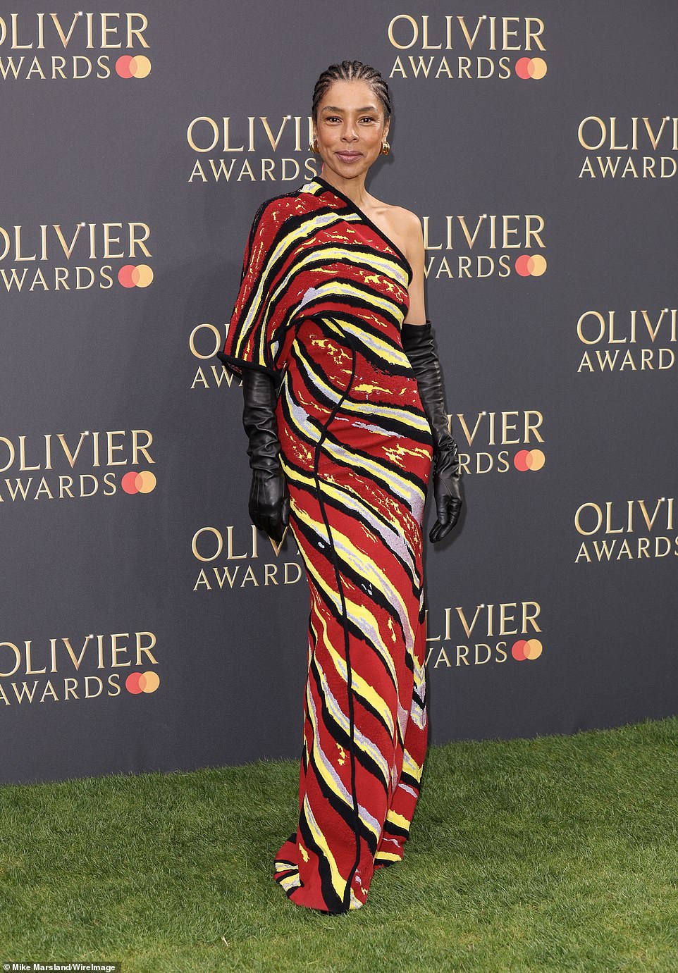 Sophie Okonedo, 55, stood out from the crowd in a stunning one-shouldered gown adorned in a striped red, black and yellow pattern