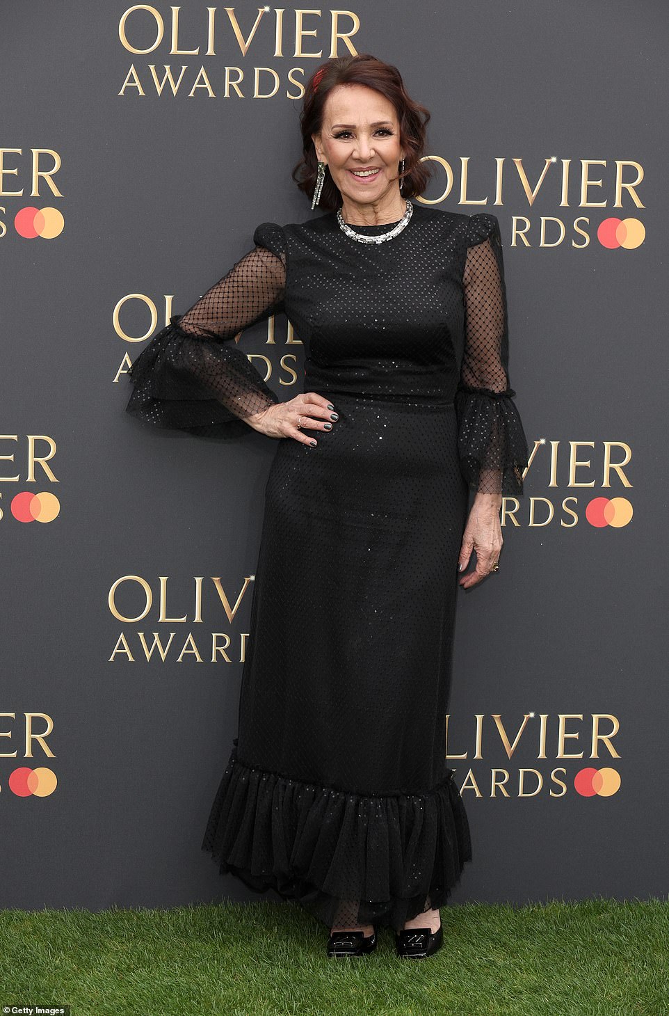 Arlene Phillips, who is up for the Gillian Lynne Award for best theatre choreographer, dazzled in a black ruffled gown with sheer sleeves