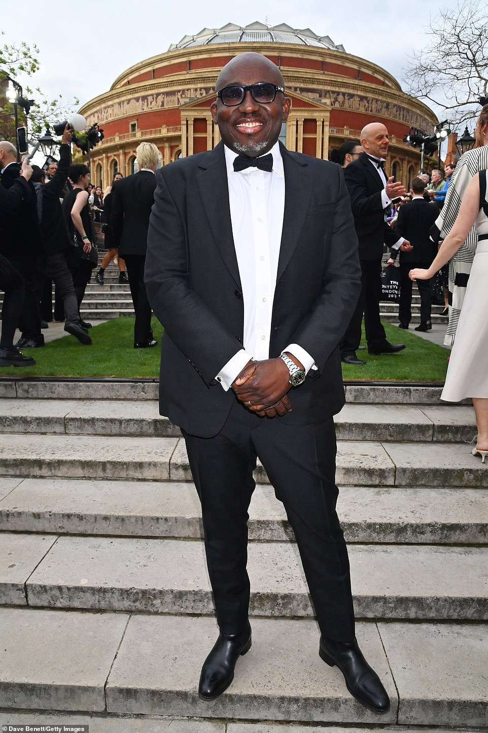 Edward Enninful looked suave in a classic black suit, white shirt and small bow tie, while donning tinted shades