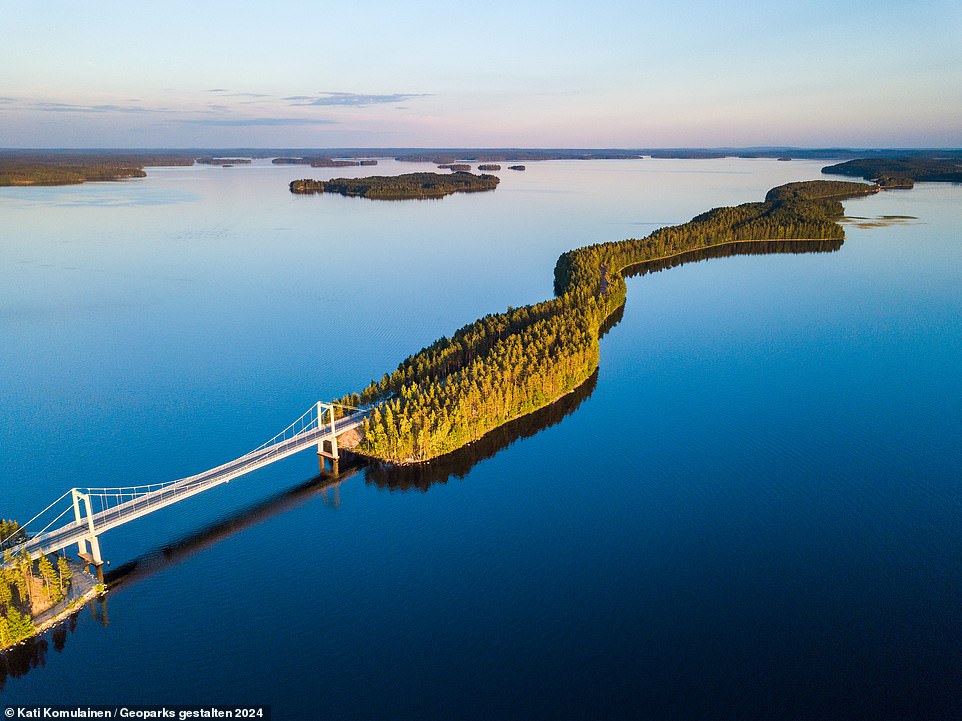 SALPAUSSELKA, FINLAND: The Salpausselka Unesco geopark is a 'land of glaciers but also of more than 800 lakes', notes the tome. Pictured here is the narrow Pulkkilanharju Esker, which stretches across Finland's second-largest lake, Paijanne. An esker is a glacial ridge, which can often 'make for lovely walks and viewpoints'