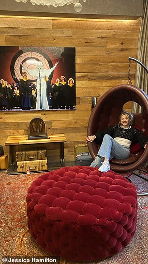 Jess ist unter einem engelhaften Bild von Dolly Parton in einem „unbequemen Eierstuhl“ im Bobby Hotel abgebildet