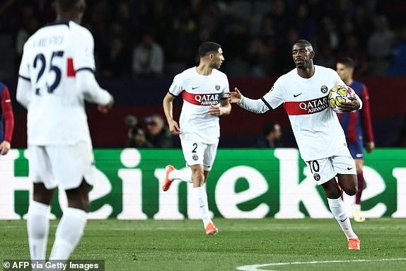 Paris Saint-Germain's French forward #10 Ousmane Dembele celebrates after scoring his team's first goal during the UEFA Champions League quarter-final second leg football match between FC Barcelona and Paris SG at the Estadi Olimpic Lluis Companys in Barcelona on April 16, 2024. (Photo by FRANCK FIFE / AFP) (Photo by FRANCK FIFE/AFP via Getty Images)