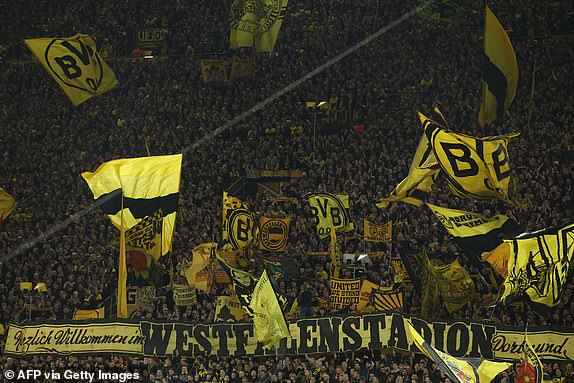 Dortmund fans wave flags prior to the UEFA Champions League quarter-final second leg football match between Borussia Dortmund and Atletico Madrid in Dortmund, western Germany on April 16, 2024. (Photo by Odd ANDERSEN / AFP) (Photo by ODD ANDERSEN/AFP via Getty Images)