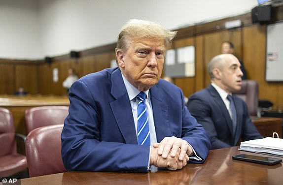 Former President Donald Trump awaits the start of proceedings on the second day of jury selection at Manhattan criminal court, Tuesday, April 16, 2024, in New York. Donald Trump returned to the courtroom Tuesday as a judge works to find a panel of jurors who will decide whether the former president is guilty of criminal charges alleging he falsified business records to cover up a sex scandal during the 2016 campaign.  (Justin Lane/Pool Photo via AP)