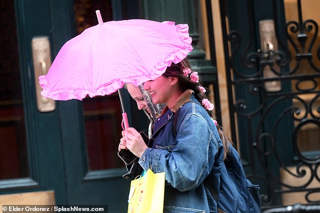 Suri held her pink umbrella aloft while celebrating her milestone birthday in New York City