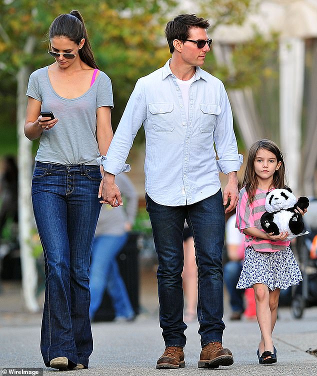 Tom Cruise has not been pictured in public with his daughter Suri for more than a decade (pictured with Holmes and Suri in 2011, a year before Holmes filed for divorce)