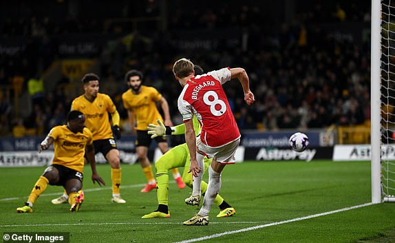 WOLVERHAMPTON, ENGLAND - APRIL 20: Martin Odegaard of Arsenal scores his team's second goal as Jose Sa of Wolverhampton Wanderers (obscured) fails to make a save during the Premier League match between Wolverhampton Wanderers and Arsenal FC at Molineux on April 20, 2024 in Wolverhampton, England. (Photo by Gareth Copley/Getty Images)