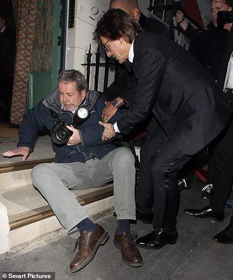 As crowds gathered outside the swanky club the actor found himself tumbling into a waiting photographer