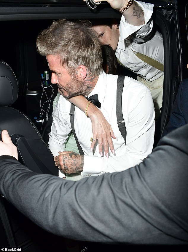 Victora held on tight as David and son Cruz helped the sozzled former singer into the car