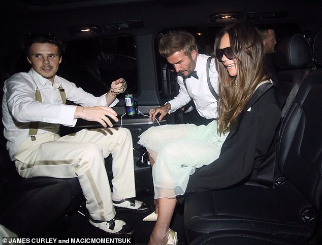 Victoria looked the worse for wear as David helped his wife into the back of a waiting car