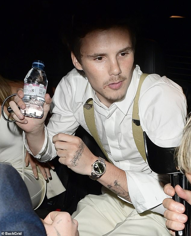 Cruz sipped a bottle of Evian water after spending the night helping his mum celebrate