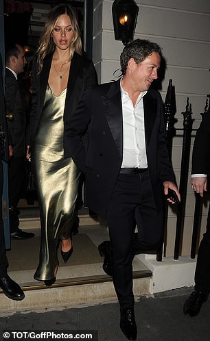 Jessica looked stunning in an elegant silk gown as she followed him out of the venue