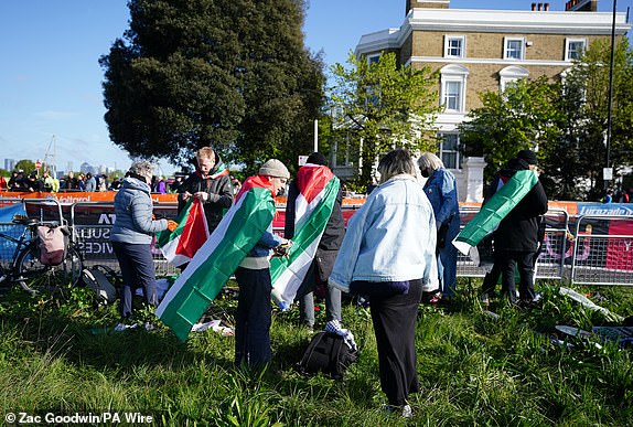 Competitors with Palestine flags in Blackheath before the TCS London Marathon. Picture date: Sunday April 21, 2024. PA Photo. See PA story ATHLETICS London. Photo credit should read: Zac Goodwin/PA Wire.RESTRICTIONS: Use subject to restrictions. Editorial use only, no commercial use without prior consent from rights holder.