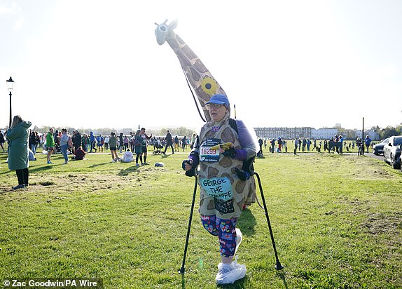 A competitor dressed as a giraffe in Blackheath before the TCS London Marathon. Picture date: Sunday April 21, 2024. PA Photo. See PA story ATHLETICS London. Photo credit should read: Zac Goodwin/PA Wire.RESTRICTIONS: Use subject to restrictions. Editorial use only, no commercial use without prior consent from rights holder.