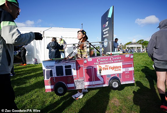 A competitor dressed as a fire engine in Blackheath before the TCS London Marathon. Picture date: Sunday April 21, 2024. PA Photo. See PA story ATHLETICS London. Photo credit should read: Zac Goodwin/PA Wire.RESTRICTIONS: Use subject to restrictions. Editorial use only, no commercial use without prior consent from rights holder.