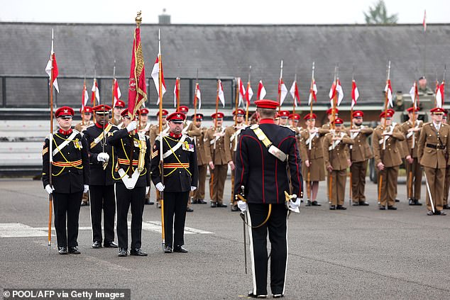 Royal Lancers stand guard during a parade to mark the Queen's arrival