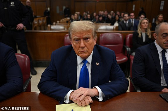 Former U.S. president and Republican presidential candidate Donald Trump looks on at Manhattan Criminal Court during his trial for allegedly covering up hush money payments linked to extramarital affairs in New York, U.S., April 22, 2024. ANGELA WEISS/Pool via REUTERS