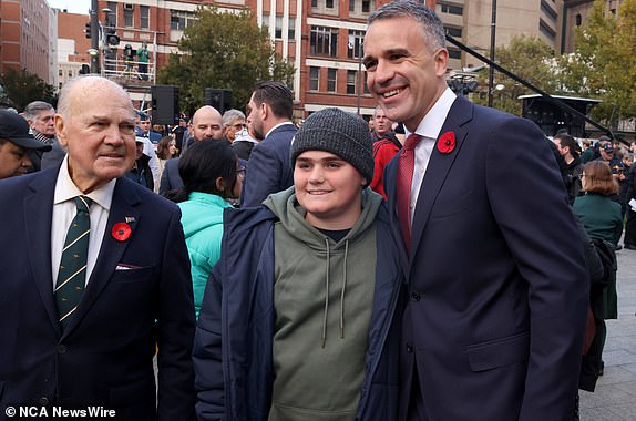 ADELAIDE, AUSTRALIA - NewsWire Photos 25,April, 2024: South Australian Premier Peter Malinauskas poses for a photo with a young man at the ANZAC Dawn service at the National War Memorial in Adelaide  Picture: NCA NewsWire / Kelly Barnes