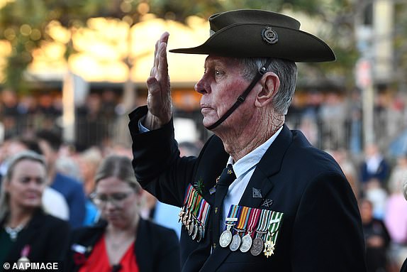 A veteran salutes during Anzac Day Dawn Service at Elephant Rock in Currumbin on the Gold Coast, Thursday, April 25, 2024. (AAP Image/Jono Searle) NO ARCHIVING
