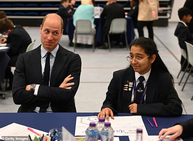 Prince William speaks with students during a visit to St. Michael's Church of England High School in Rowley Regis today