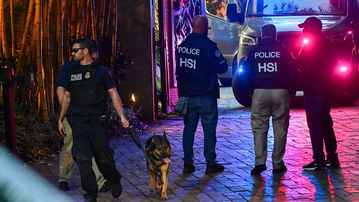 HSI-Agenten stehen nachts mit einem Polizei-K9 vor Diddys Haus
