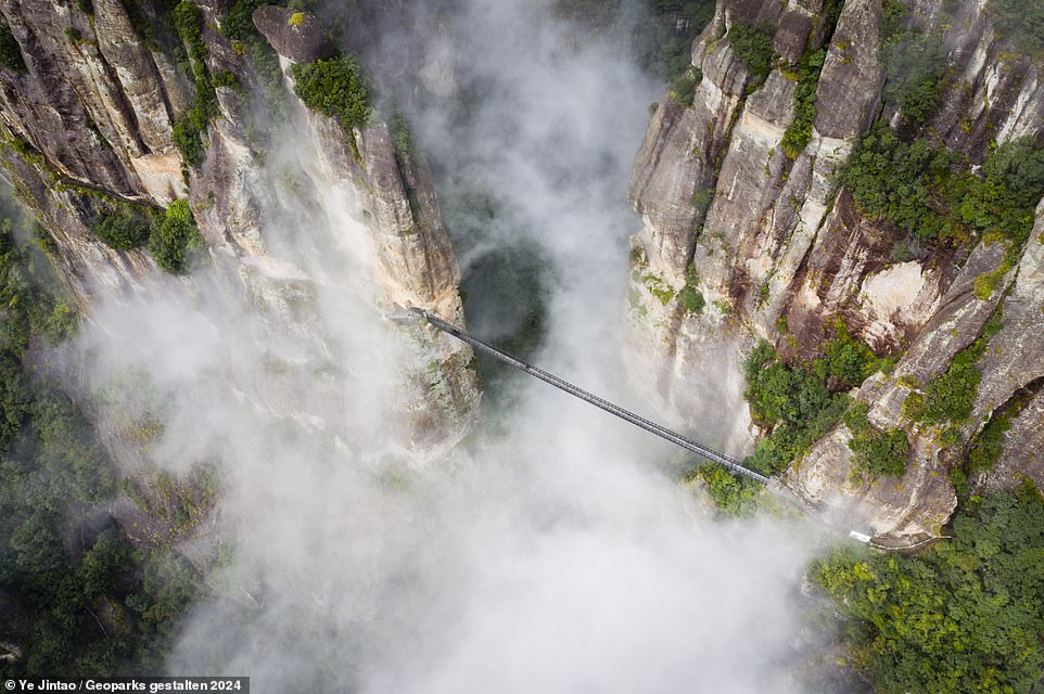 YANDANGSHAN, CHINA: This picture was taken in an area 'where ancient wonders unfold'. This extraordinary canyon, pictured in the mist, shows how the Earth's surface moved dramatically more than 100million years ago, according to the tome. One tectonic plate, called the Kula-Pacific Plate, slid beneath another, the Asian Continental Plate, unleashing 'colossal' volcanic eruptions that 'sculpted the region's peaks', it explains. When to visit: March to June, September to December