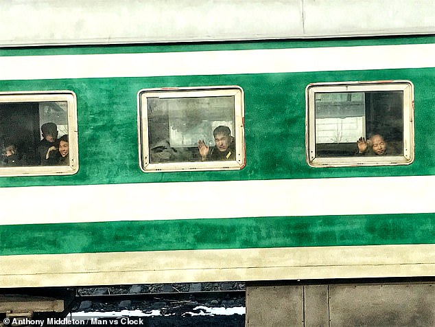 The sleeper train, pictured, passes through the North Korean countryside on an eight-hour journey. Pictured: Local people waved at Anthony through the window of the train