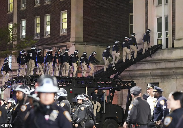 Dozens of cops poured in using a ramp attached to a Lenco ballistic engineered armored response vehicle to access an upper window