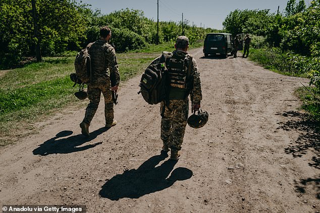 Ukrainian soldiers from the 30th mechanised brigade walk at an artillery position in Sloviansk, Donetsk Oblast, Ukraine on April 30