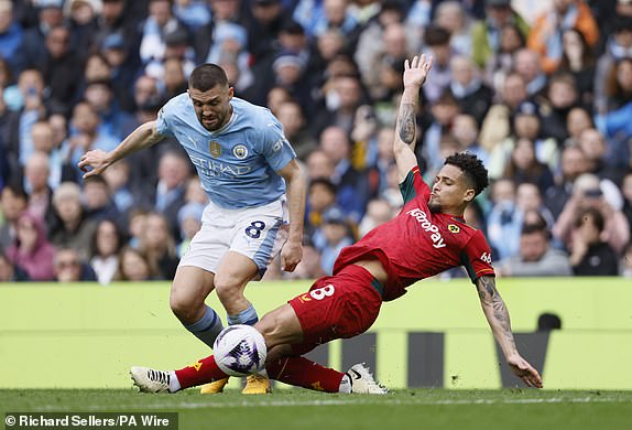 Manchester City's Mateo Kovacic (left) and Wolverhampton Wanderers' Joao Gomes battle for the ball during the Premier League match at the Etihad Stadium, Manchester. Picture date: Saturday May 4, 2024. PA Photo. See PA story SOCCER Man City. Photo credit should read: Richard Sellers/PA Wire.RESTRICTIONS: EDITORIAL USE ONLY No use with unauthorised audio, video, data, fixture lists, club/league logos or "live" services. Online in-match use limited to 120 images, no video emulation. No use in betting, games or single club/league/player publications.