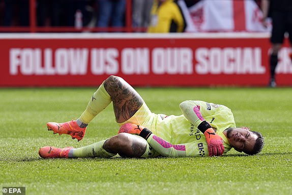 epa11306929 Ederson of Manchester City goes down injured during the English Premier League soccer match between Nottingham Forest and Manchester City, in Nottingham, Britain, 28 April 2024.  EPA/TIM KEETON EDITORIAL USE ONLY. No use with unauthorized audio, video, data, fixture lists, club/league logos, 'live' services or NFTs. Online in-match use limited to 120 images, no video emulation. No use in betting, games or single club/league/player publications.