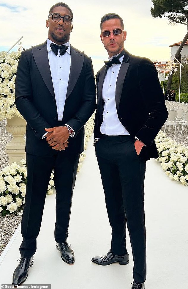 Professional boxer Anthony Joshua swapped his boxing gloves for a formal suit for the day as he got snapped next to pal Scott Thomas, 35