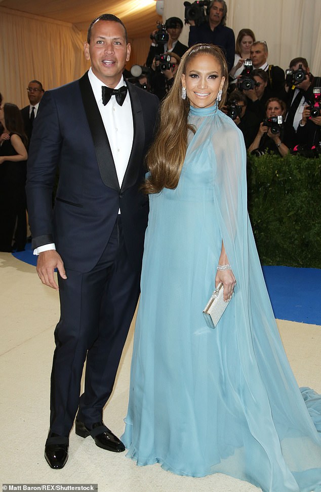 The diva harked back to the 1970s in a long blue gown with her hair worn down her chest and diamond earrings as an accent. She took with her Alex Rodriguez for the first time